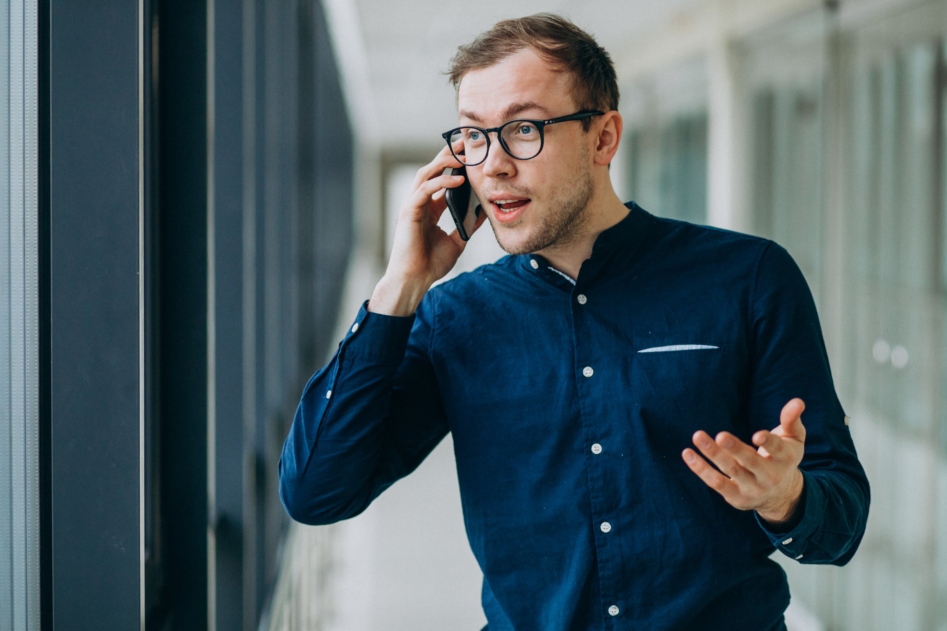 young-handsome-man-talking-phone-office
