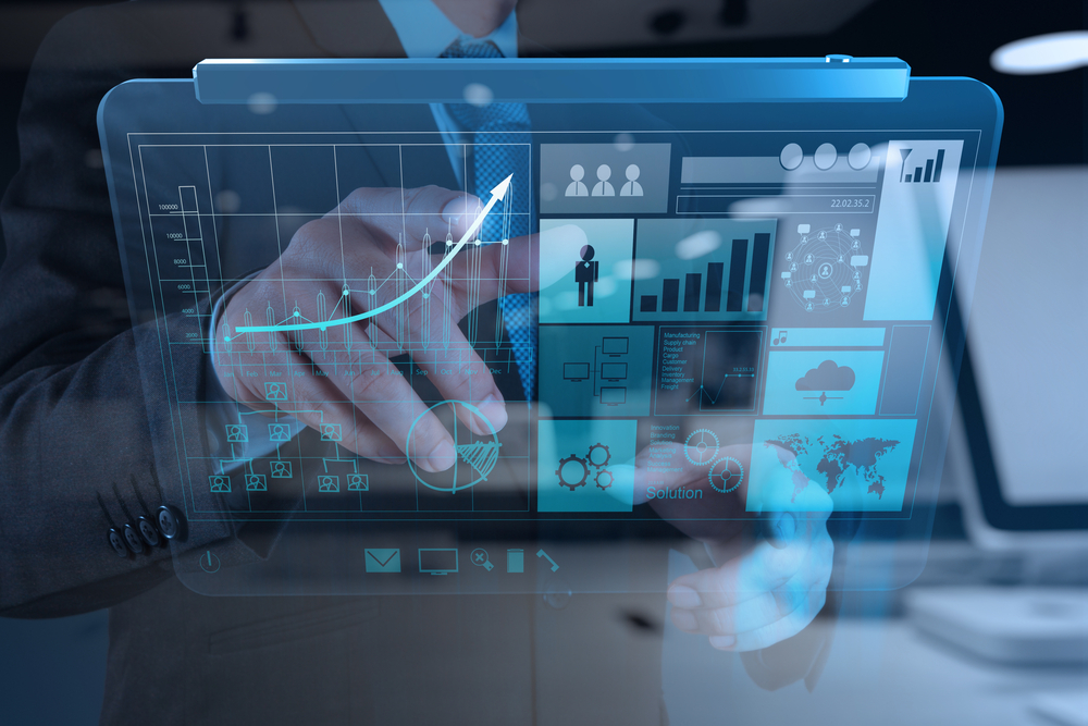 Hand pointing at business growth charts on a digital screen, representing SaaS lead generation and successful sales pipeline growth