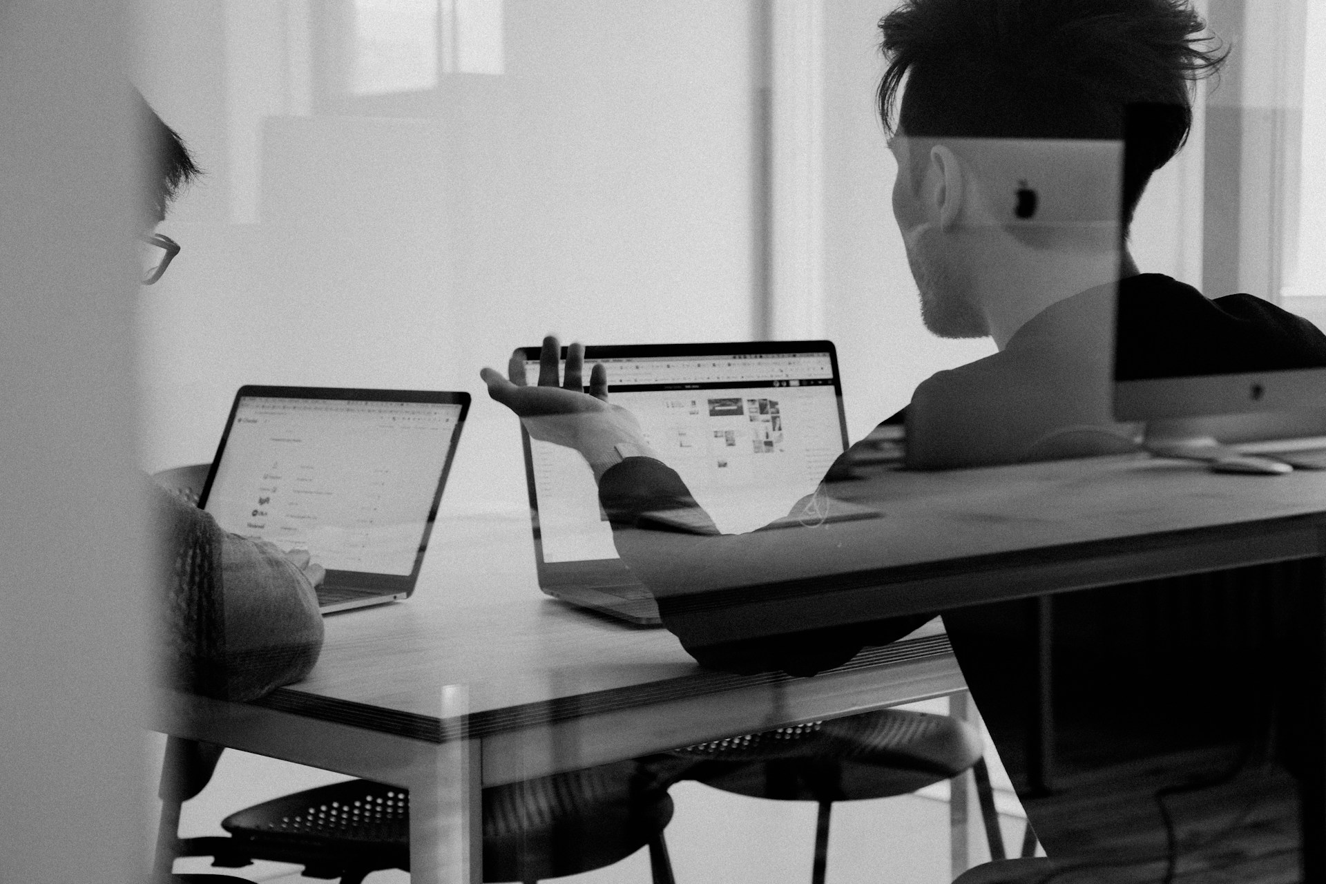 Black and white image of a professional working at a laptop, representing smarter outbound lead generation and B2B sales prospecting