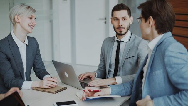 Business professionals in suits meeting in an office